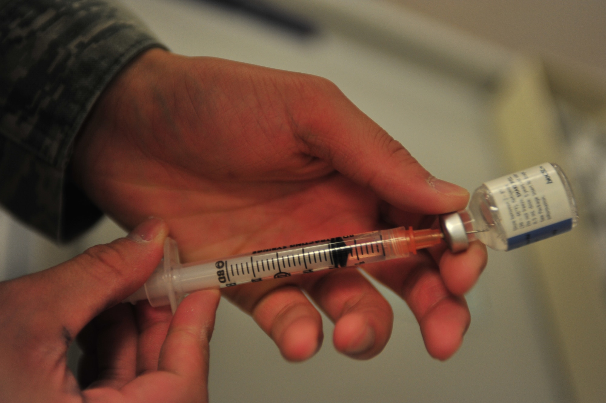 Senior Airman David Hoang, 5th Medical Operations Squadron allergy and immunizations technician, fills a syringe at Minot Air Force Base, N.D., Sept. 16, 2015. The Immunization Clinic offers immunizations for viruses such as the flu and smallpox as well as allergy relief and pediatric shots. (U.S. Air Force photo/Senior Airman Stephanie Morris)