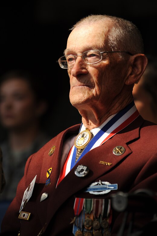 Retired U.S. Army Master Sgt. Ed Beck listens during the opening ceremony of Prisoner of War and Missing in Action remembrance week Sept. 14, 2015, at Schriever Air Force Base, Colorado. Beck was captured and held as a POW for six months during WWII. (U.S. Air Force Photo/Dennis Rogers)