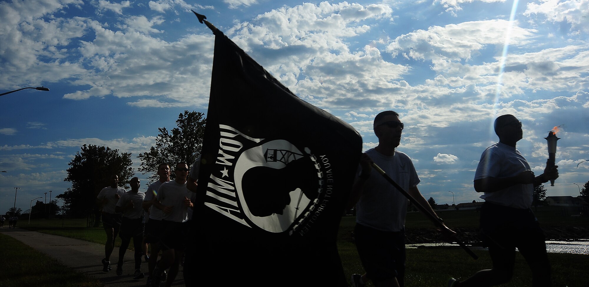 U.S. Air Force Chief Master Sgt. Shawn L. Drinkard, command chief of the 509th Bomb Wing, with members of of the 509th Bomb Wing participate in the annual Prisoners of War/Missing in Action run at Whiteman Air Force Base, Mo., Sept.18, 2015. Airmen from each squadron volunteered to take part in a 24-hour memorial run. (U.S. Air Force photo by Airman 1st Class Jovan Banks/Released)
