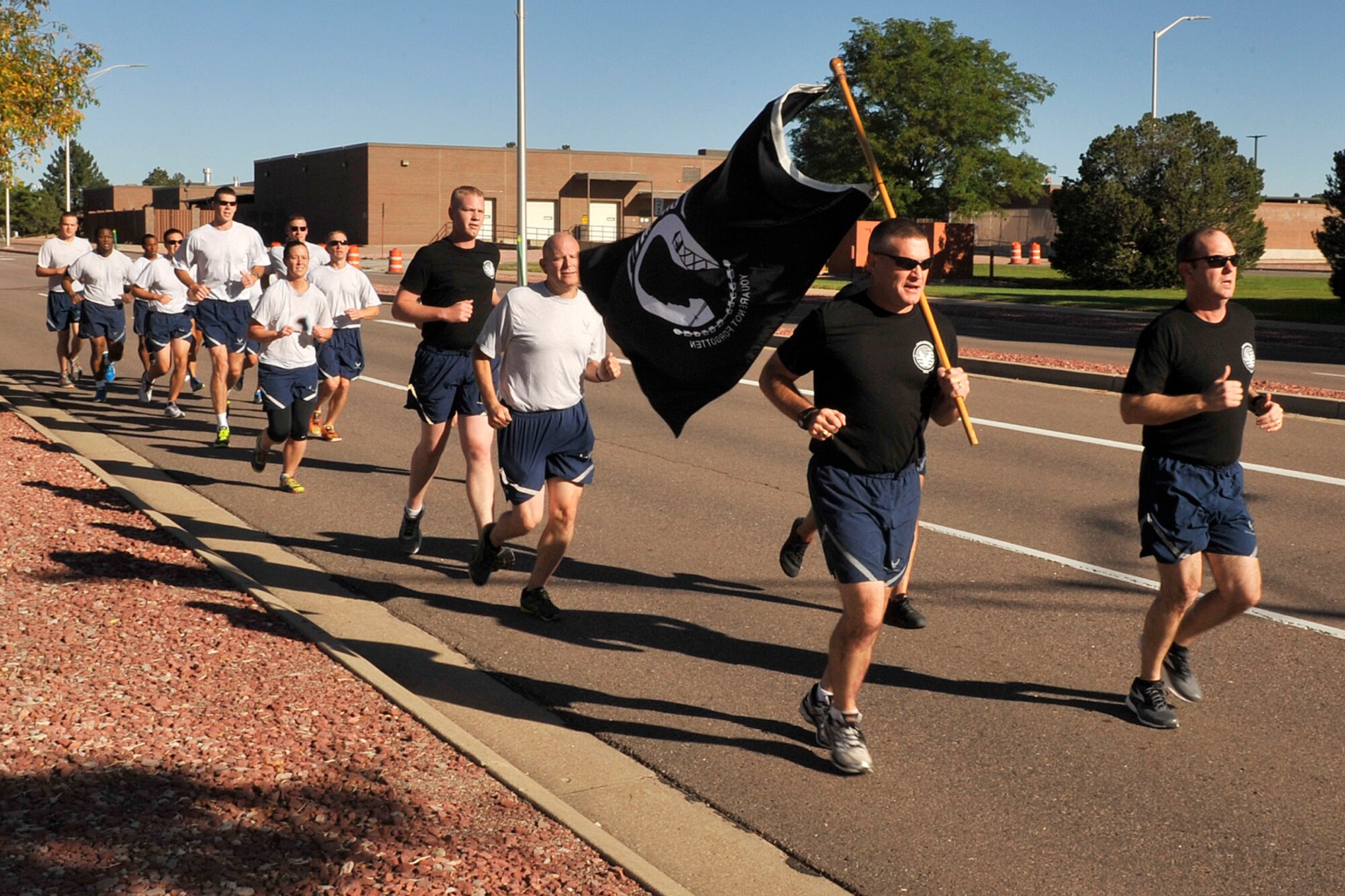 PETERSON AIR FORCE BASE, Colo. – Col. Douglas Schiess, 21st Space Wing commander (right) and Col. Eric Dorminey, 21st Space Wing vice commander (left),  lead the first leg of the POWMIA 24-hour run here Sept. 17, 2015. (U.S. Air Force photo by Dennis Howk)