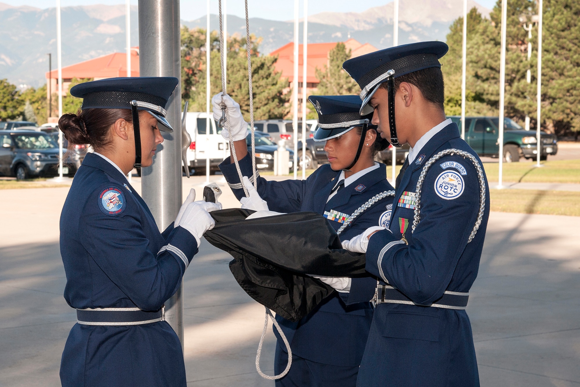 Members of the Mitchell High School Air Force Junior ROTC color guard prepare to attach and raise the Prisoner of War/Missing in Action Flag on Peterson Air Force Base on Sept. 16, 2015. This early morning ceremony during reveille kicked off a week of remembrance and began the National Prisoner of War/Missing in Action Recognition and is observed from Sept. 17-18.  (U.S. Air Force photo by Craig Denton)