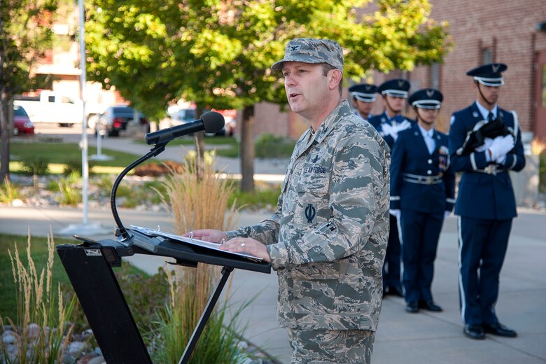 Col. Douglas Schiess, 21st Space Wing commander, addresses Team Pete personnel during a Prisoner of War/Missing in Action Flag Raising Ceremony held at the Vosler Noncommissioned Officer Academy on Peterson Air Force Base on Sept. 16, 2015.  This early morning gathering kicked off several events to include a POW-MIA retreat ceremony, 24-hour run and a remembrance ceremony at the base chapel. (U.S. Air Force photo by Craig Denton)