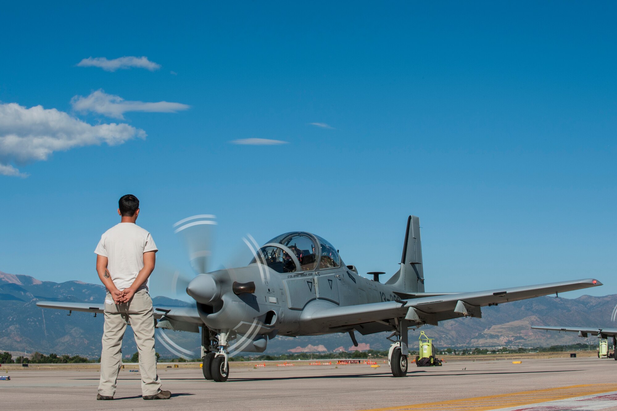 PETERSON AIR FORCE BASE, Colo. – An Afghan maintainer waits as an 81st Fighter Squadron instructor pilot and Afghan pilot get ready to take off for high altitude training Sept. 16, 2015 at Peterson Air Force Base. Afghan pilots have been training with the 81st FS at Moody AFB, Ga. with A-29B Super Tucanos and came to Peterson for the high altitude and mountainous terrain training that can then be taken back to their home country. Training was for both Afghan pilots and 81st FS instructor pilots to gain more knowledge and instructor techniques. (U.S. Air Force photo by Airman 1st Class Rose Gudex)