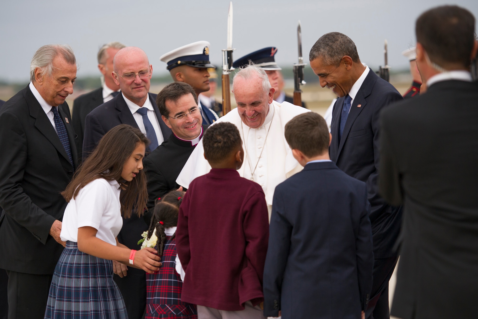 Pope Francis and President Barack Obama are greeted by catholic school children on the flightline on Joint Base Andrews, Md., Sept. 22, 2015. The children are local to the National Capital Region and presented the pope with a gift of flowers. (U.S. Air Force Photo/Tech. Sgt. Robert Cloys)