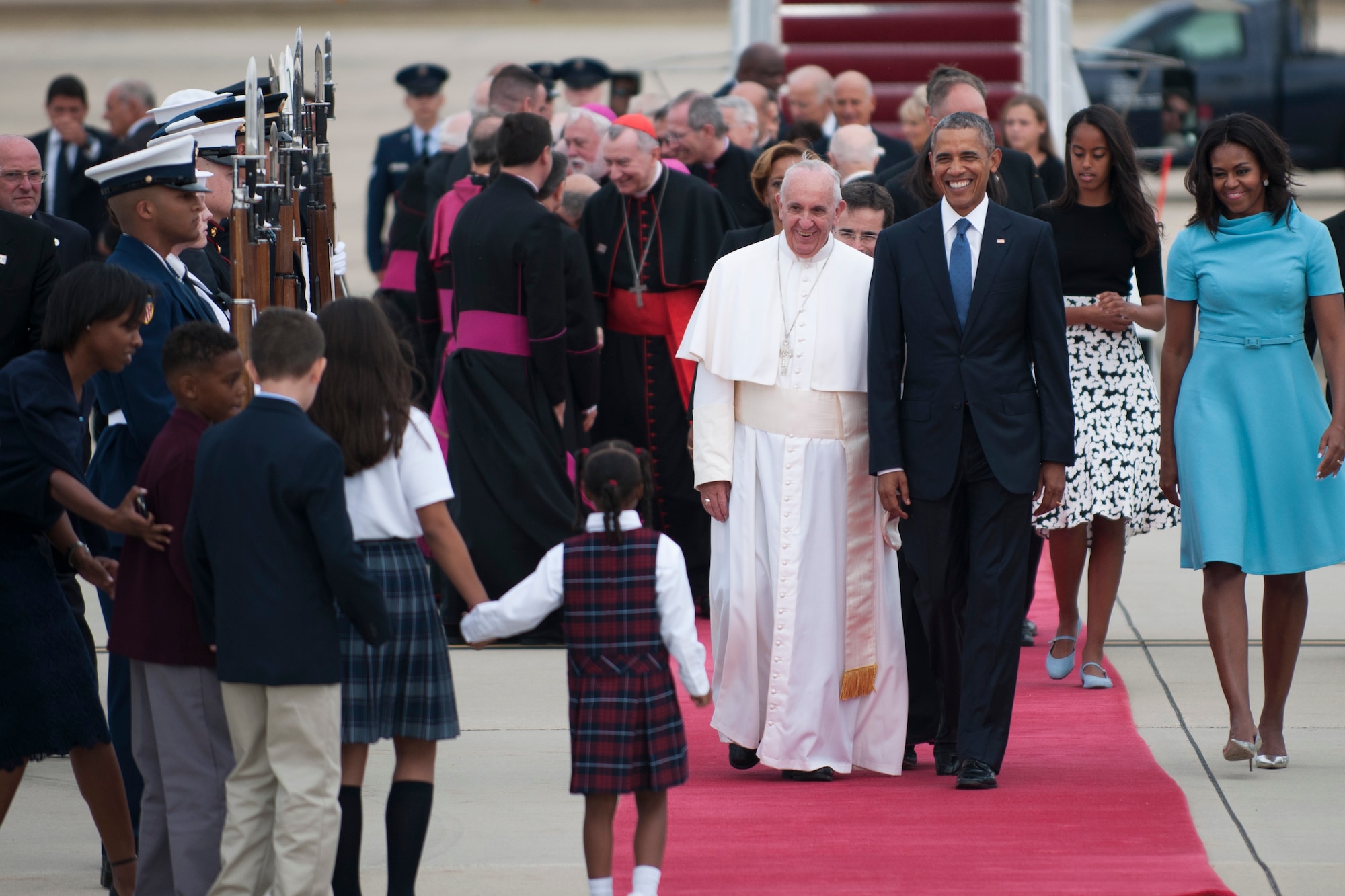 Pope Francis and President Barack Obama are greeted by catholic school children on the flightline on Joint Base Andrews, Md., Sept. 22, 2015. The children are local to the National Capital Region and presented the pope with a gift of flowers. (U.S. Air Force photo/Airman 1st Class Philip Bryant)