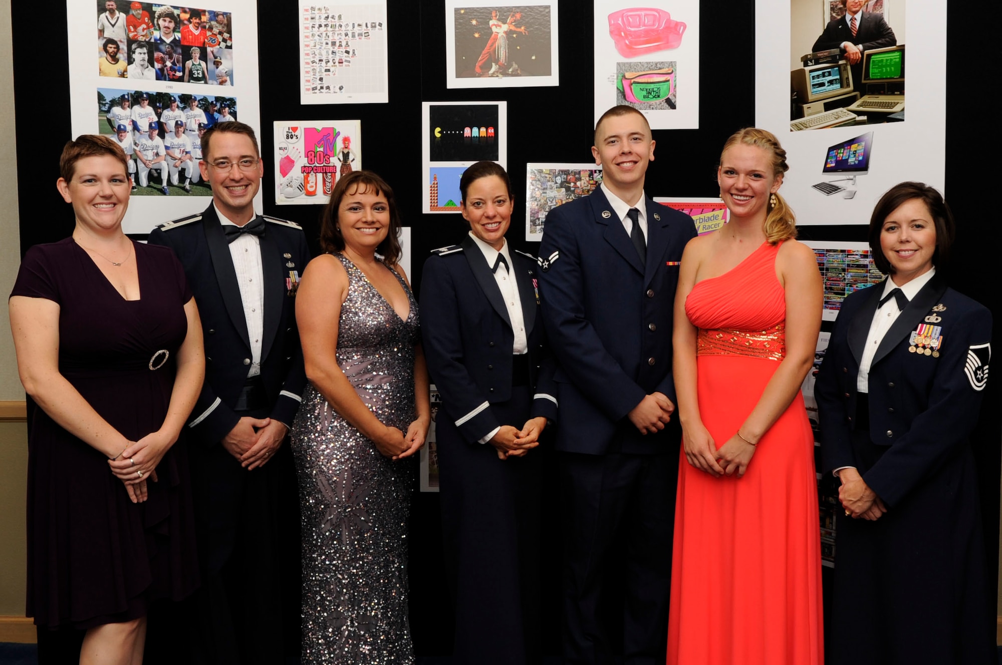 Members of the 30th Space Wing legal office, and their guests, pose for a photo in front of a display at the Air Force Ball, Sept. 18, 2015, Vandenberg Air Force Base, Calif. Celebrating decades of air superiority and technological innovation, the theme of this year’s event was “Back to our future”, which aimed to highlight the connection between the Air Force’s past and future – while building camaraderie among participants. (U.S. Air Force photo by Senior Airman Shane Phipps/Released)