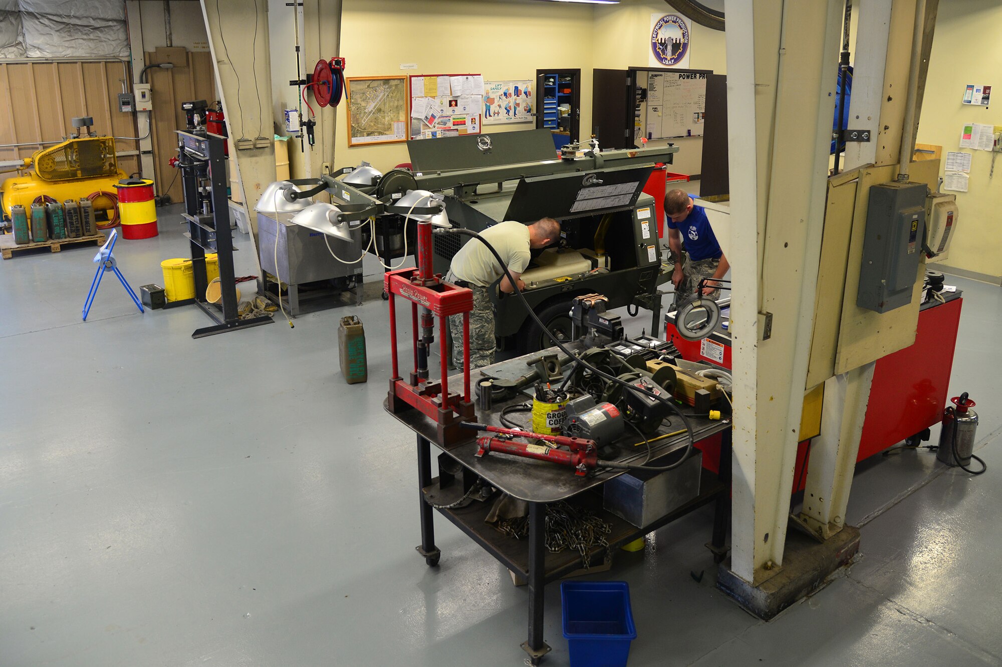 Senior Airmen Blake Rodgers and Ryan Girard, 341st Civil Engineer Squadron power production journeymen, work together to diagnose and repair problems on a light cart Sept. 17, 2015, at Malmstrom Air Force Base, Mont. The Airmen are responsible for the upkeep of multiple light carts, around $17,000 apiece, for a fleet value of a near $105,000. (U.S. Air Force photo/Airman Daniel Brosam)