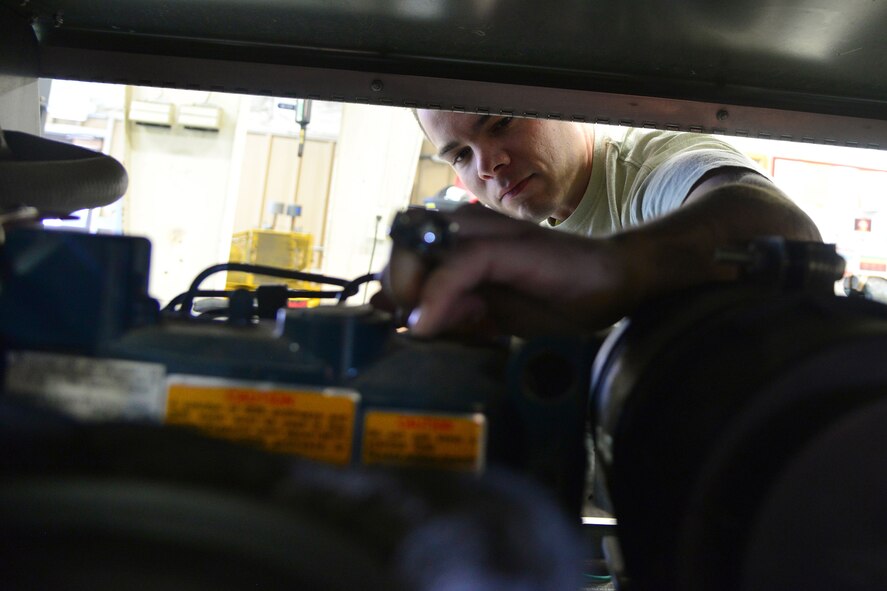 Senior Airman Blake Rodgers, 341st Civil Engineer Squadron power production journeyman, tightens a bolt on a light cart engine Sept. 17, 2015, at Malmstrom Air Force Base, Mont. These light carts are used to provide light in the field, at events or as a backup light source when the power goes out. (U.S. Air Force photo/Airman Daniel Brosam)