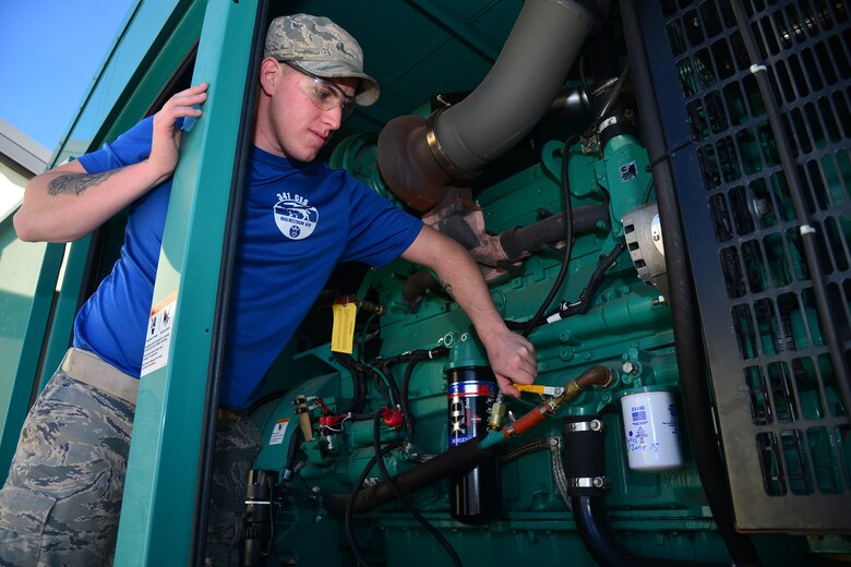 Senior Airman Ryan Girard, 341st Civil Engineer Squadron power production journeyman, checks the gauges and levers on a generator Sept. 17, 2015, at Malmstrom Air Force Base, Mont. These generators can provide enough power to produce 5.8 megawatt-hours, enough to power the entire base. (U.S. Air Force photo/Airman Daniel Brosam)