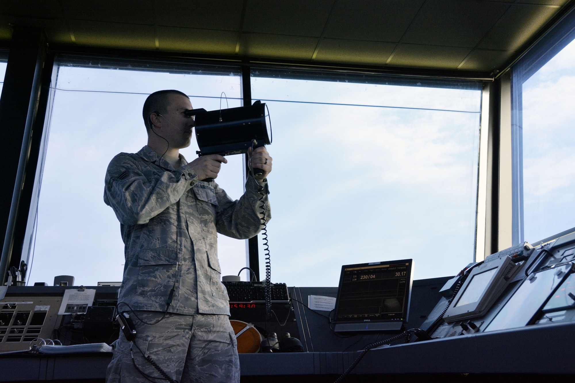 U.S. Air Force Senior Airman Justin W. Condon, 235th Air Traffic Control Squadron, local controller for airborne aircraft, conducts a light gun signal check with approaching aircraft, July 8, 2105. This device is used as a means of communicating with aircraft in case of radio failure. The 235th ATCS provides air traffic control services for all civilian and military aircraft at the Stanly County Airport, New London, N.C. (U.S. Air National Guard photo by Master Sgt. Patricia F. Moran, 145th Public Affairs/Released)
