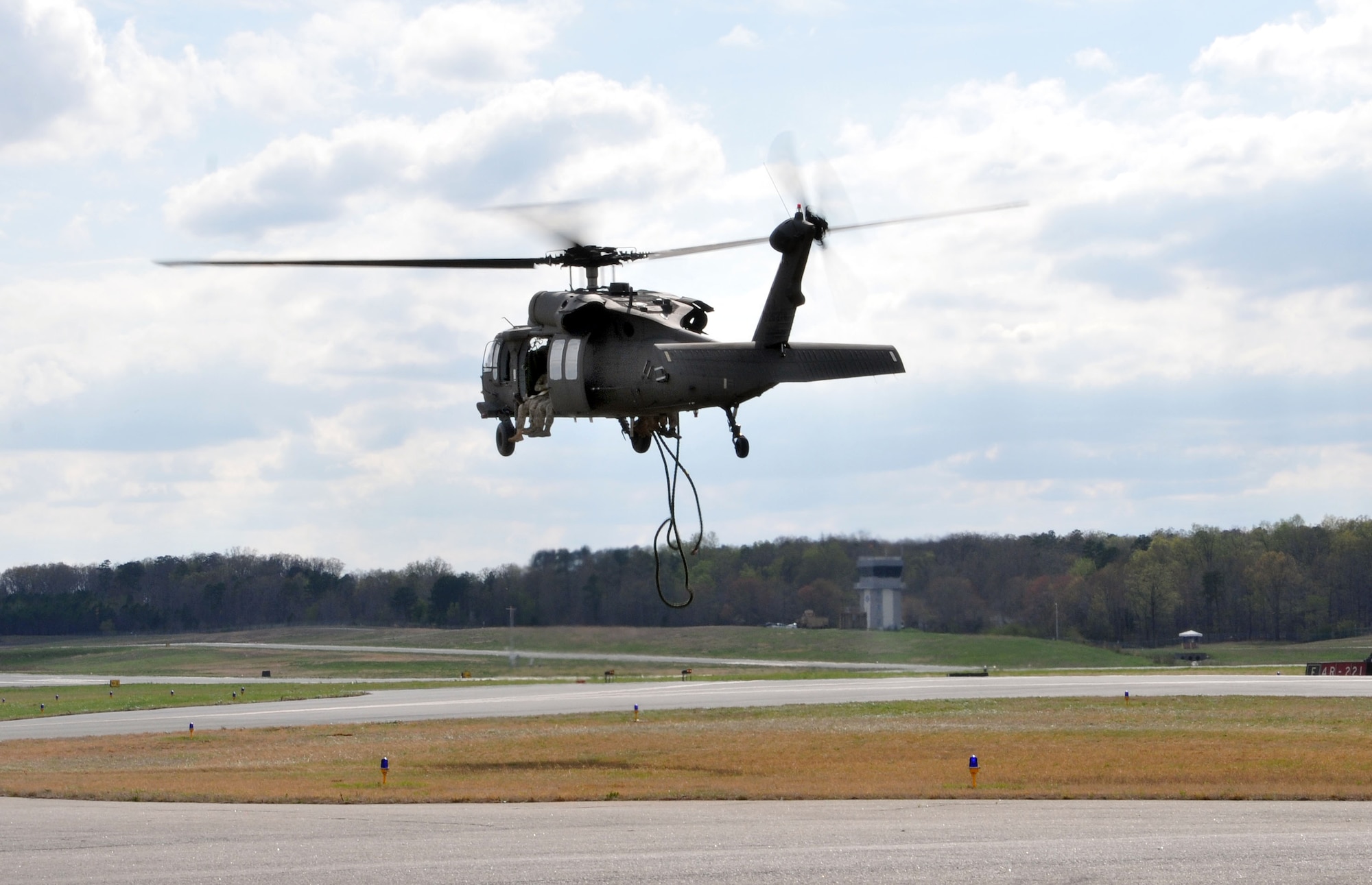 Members of the 118th Air Support Operations Squadron communicate with 235th Air Traffic Controllers who watch the skies from the control tower at Stanly County Airport, New London, N.C., April 8, 2015, while Soldiers from North Carolina Army National Guard, Company C, 1-131 AVN, conduct FAST rope insertion training from UH-60 Blackhawk helicopter. The 235th ATC has provided air traffic control services for all civilian and military aircraft since their infrastructure started in 1988 when they formed a partnership with Stanly County Airport. (U.S. Air National Guard photo by Master Sgt. Patricia F. Moran, 145th Public Affairs/Released)