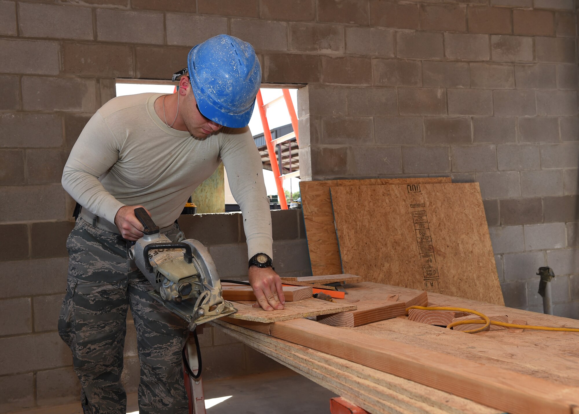 ALTUS AIR FORCE BASE, Okla. – U.S. Air Force Senior Airman Rob Black, 97th Civil Engineer Squadron structural journeyman, cuts out the corner piece of a soffit during construction of a new entomology facility, Sept. 21, 2015. The soffit is applied to the underside of the structures’ roof to enclose the area between the roof overhang and the side of the building and helps to protect the structure from external elements. This project allows the 97th CES airmen to get hands-on training they might not get during normal daily operations. (U.S. Air Force photo by Airman 1st Class Megan E. Acs/Released) 