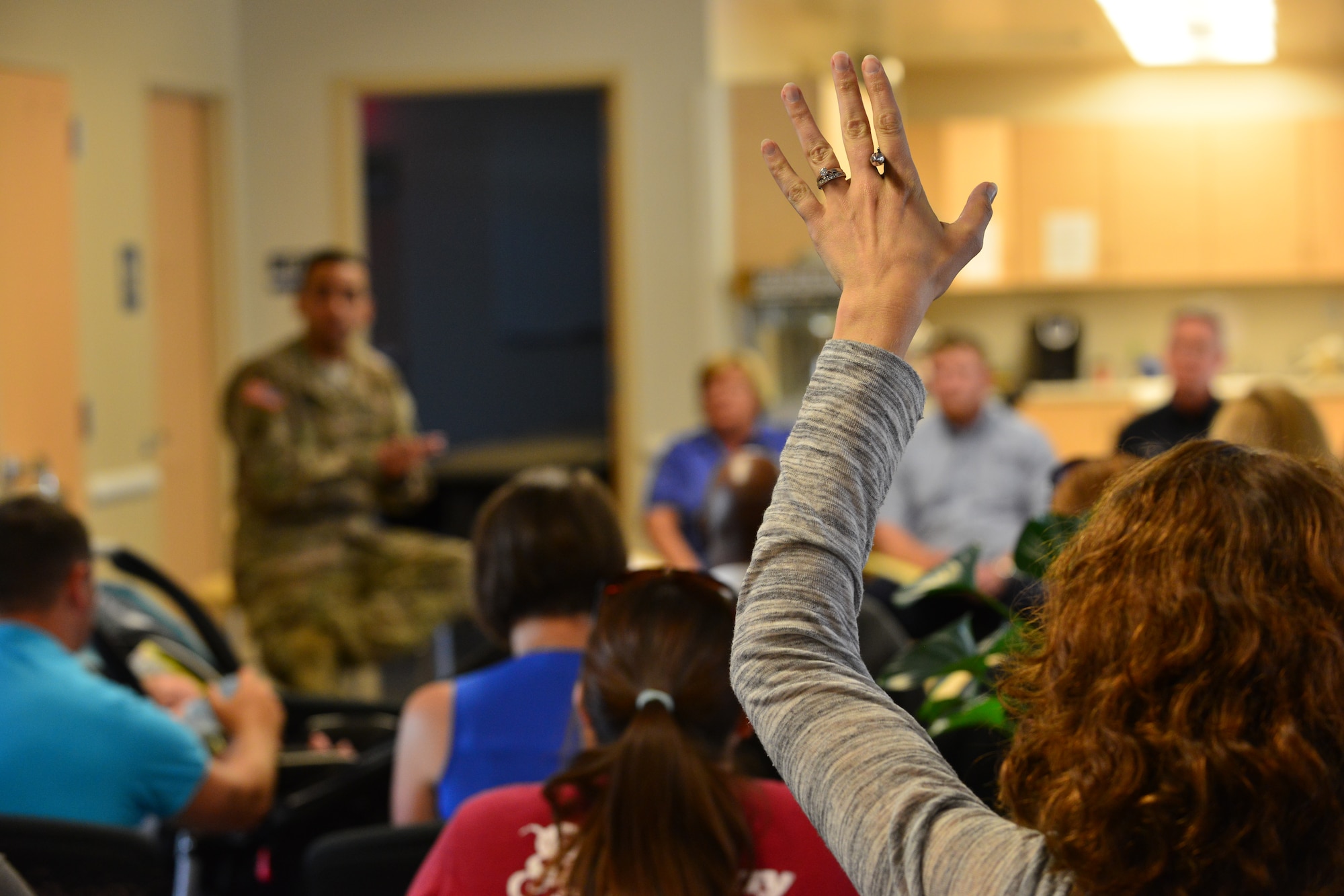 A residential working group participant raises her hand to address housing issues during a meeting at Fort Eustis, Va., Sept. 16, 2015. The group welcomes families of all ranks and provides a platform to voice issues and ideas addressed by installation leadership. (U.S. Air Force photo by Staff Sgt. Natasha Stannard/Released)