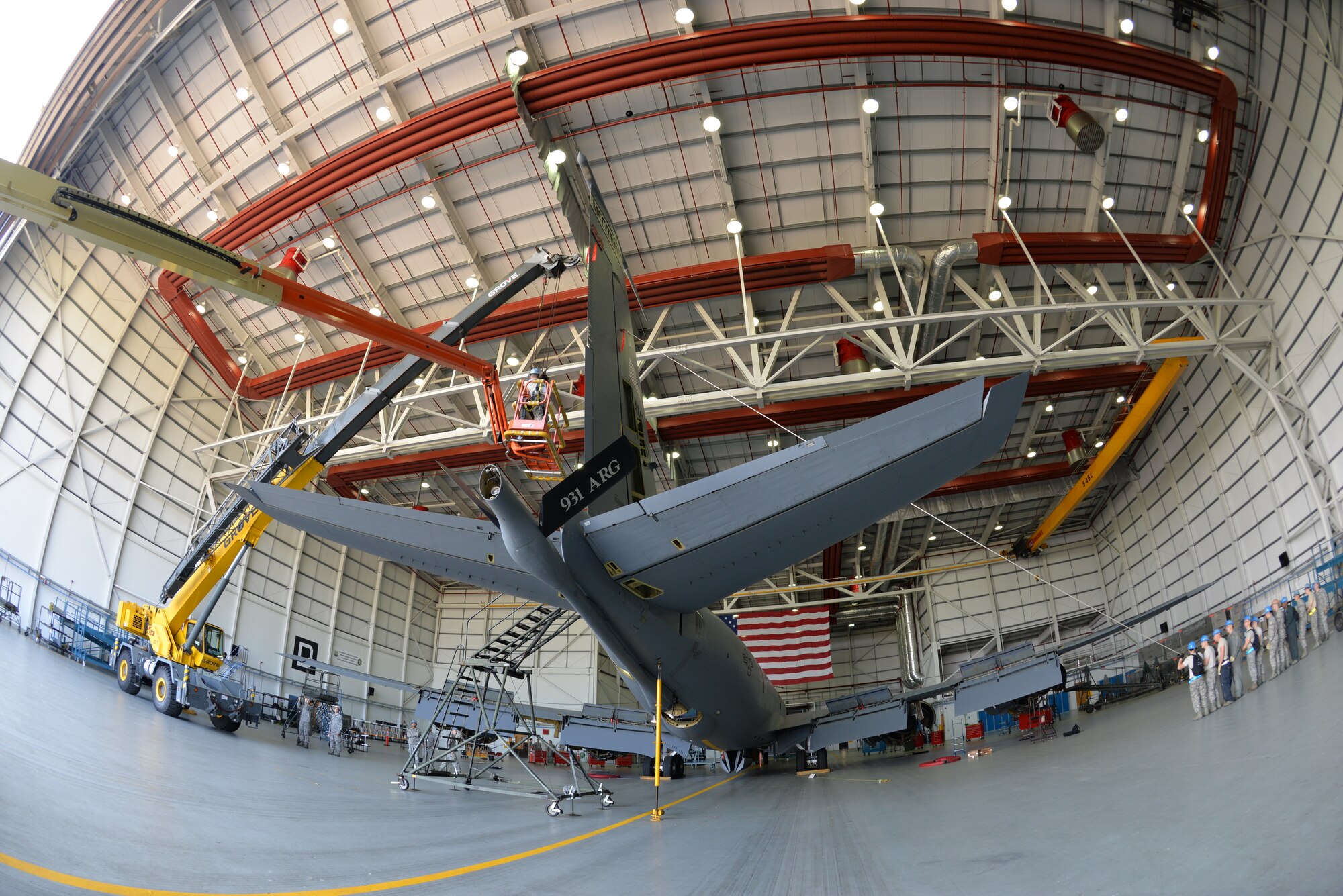 A KC-135 Stratotanker, bearing the markings of McConnell Air Force Base, undergoes an isochronal inspection as U.S. Air Force Airmen from the 100th Maintenance Squadron and 100th Aircraft Maintenance Squadron work together to perform a “fin fold” tail removal Sept. 11, 2015, on RAF Mildenhall, England. The tail was removed after the aircraft was found to have a cracked rudder during a wash before the iso inspection. (U.S. Air Force photo by Karen Abeyasekere/Released)