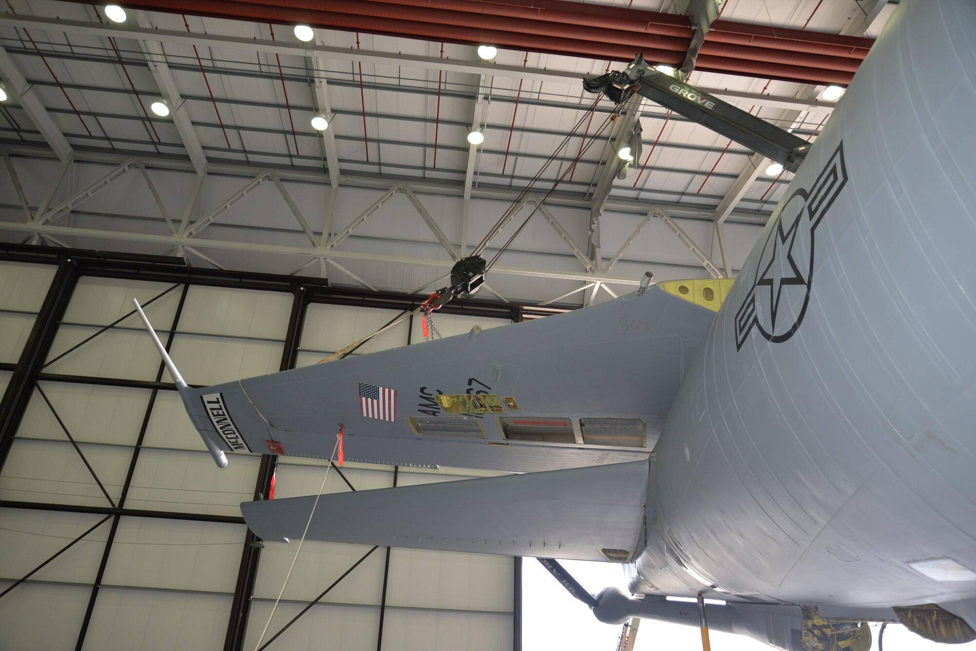 The tail of a KC-135 Stratotanker lays at 90 degrees during an isochronal inspection Sept. 11, 2015, on RAF Mildenhall, England. The aircraft part was awaiting the final bolts to be taken off before being completely removed in order to repair a cracked rudder. The jet, formerly from McConnell Air Force Base, has been reassigned to RAF Mildenhall and underwent a full isochronal inspection, with the addition of the tail removal. It will soon be repainted and given the Square D markings. (U.S. Air Force photo by Karen Abeyasekere/Released)