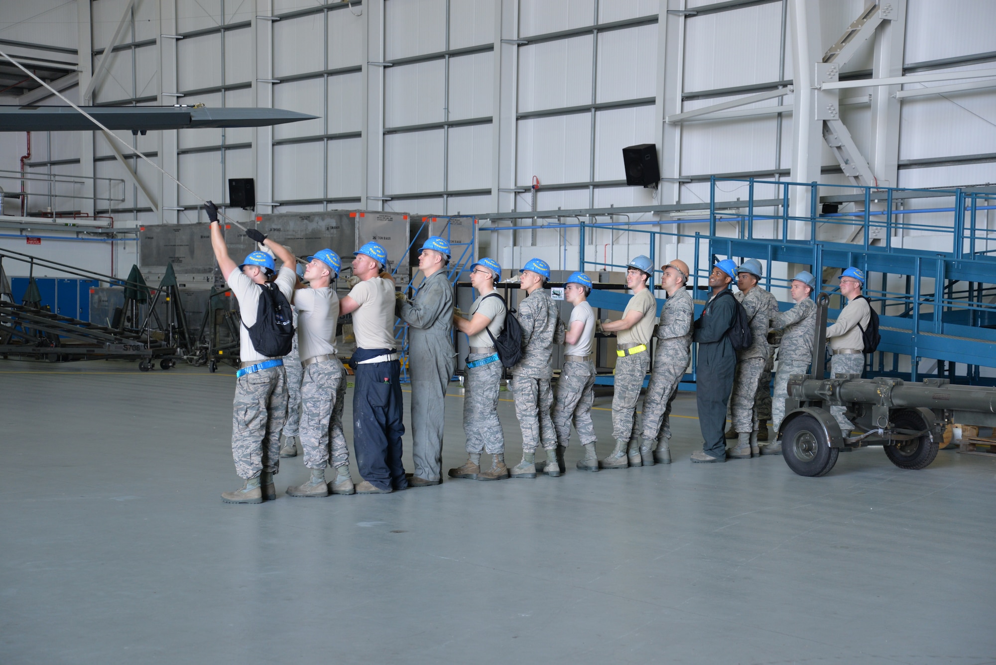 U.S. Air Force Airmen from the 100th Maintenance Squadron and 100th Aircraft Maintenance Squadron hold on to a rope attached to the tail of a KC-135 Stratotanker Sept. 11, 2015, on RAF Mildenhall, England. The tail was being removed in order to repair a cracked rudder as the aircraft underwent a full isochronal inspection. (U.S. Air Force photo by Karen Abeyasekere/Released)