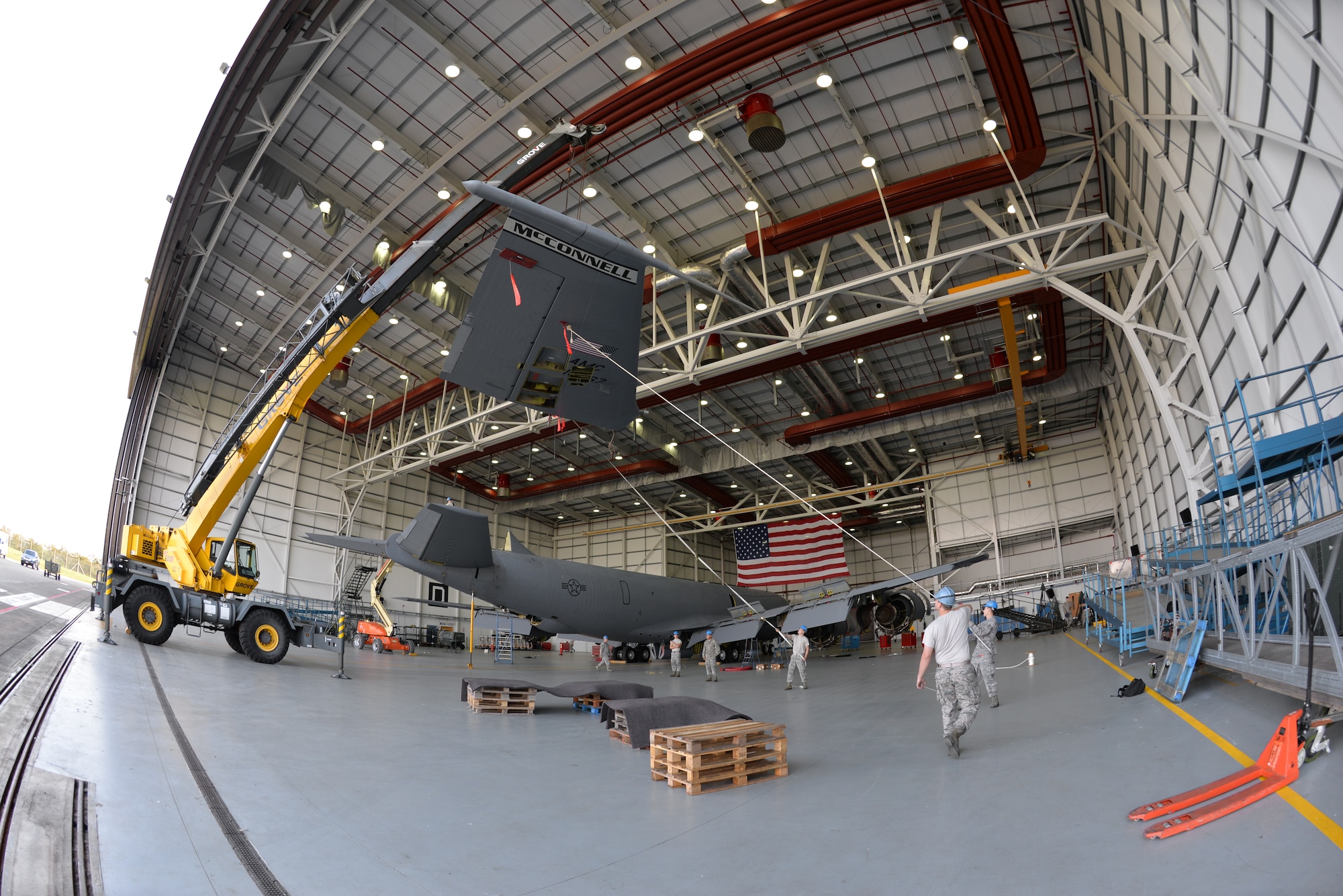 U.S. Air Force Airmen from the 100th Maintenance Squadron and 100th Aircraft Maintenance Squadron work together to perform a “fin fold” tail removal of a KC-135 Stratotanker Sept. 11, 2015, on RAF Mildenhall, England. The jet, formerly from McConnell Air Force Base, has been reassigned to RAF Mildenhall and underwent a full isochronal inspection, with the addition of the tail removal. It will soon be repainted and given the Square D markings. (U.S. Air Force photo by Karen Abeyasekere/Released)