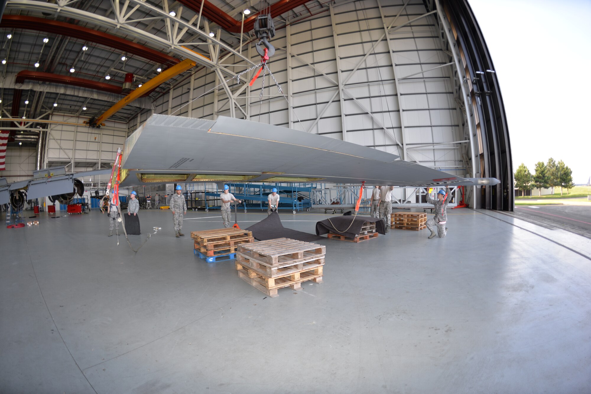 The tail of a KC-135 Stratotanker is lowered into position on top of crates during a fin fold and tail removal process Sept. 11, 2015, on RAF Mildenhall, England. The tail was also removed in order to repair a cracked rudder on the jet, formerly from McConnell Air Force Base, as it becomes part of RAF Mildenhall’s fleet of refuelers. (U.S. Air Force photo by Karen Abeyasekere/Released)