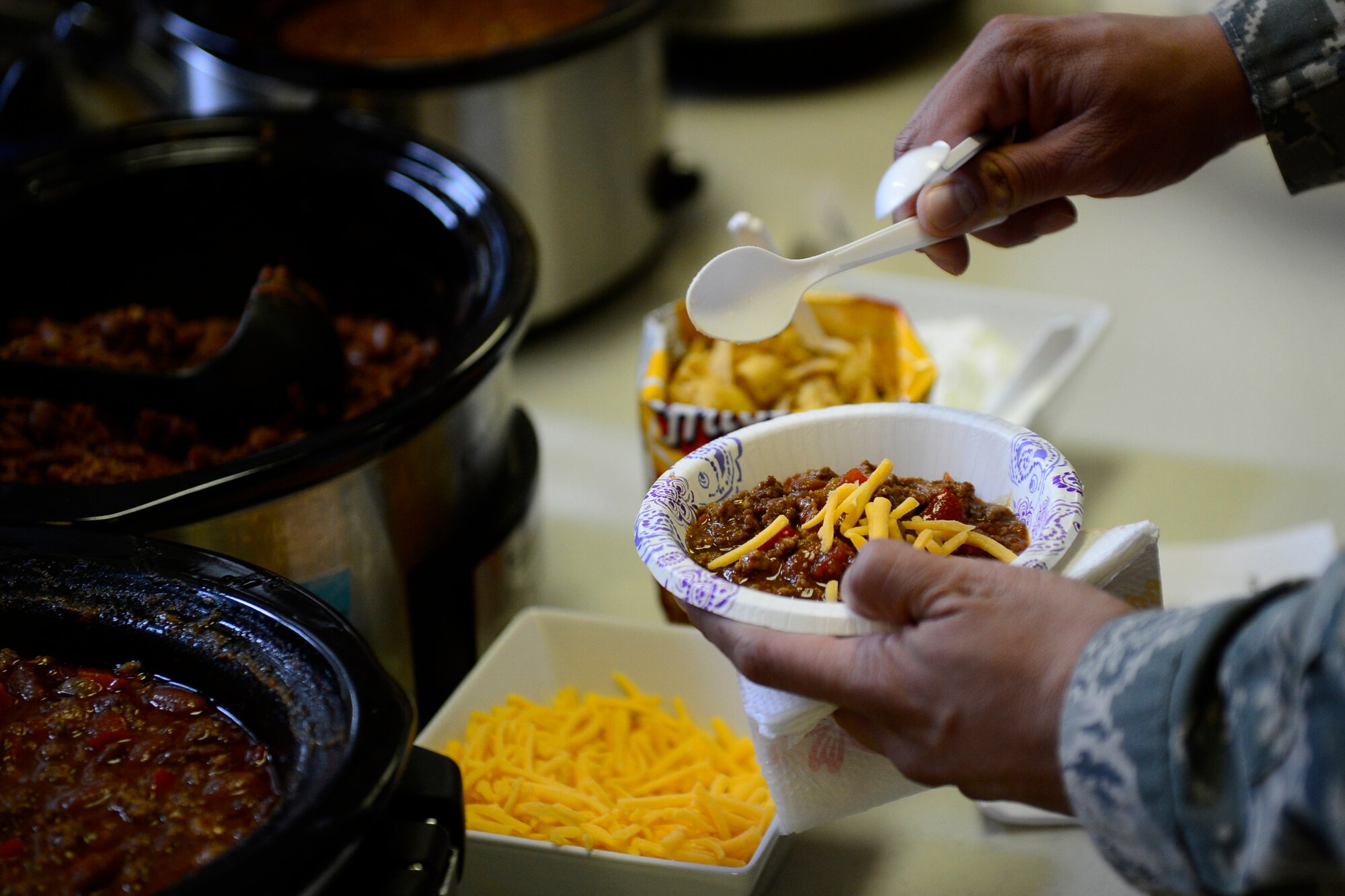 An Airman samples chili at the Combined Federal Campaign Chili Cook-off event at Royal Air Force Lakenheath, England, Sept. 21, 2015. The event provided a venue for the CFC team to spread the campaign’s message. (U.S. Air Force photo by Airman 1st Class Erin R. Babis/Released)