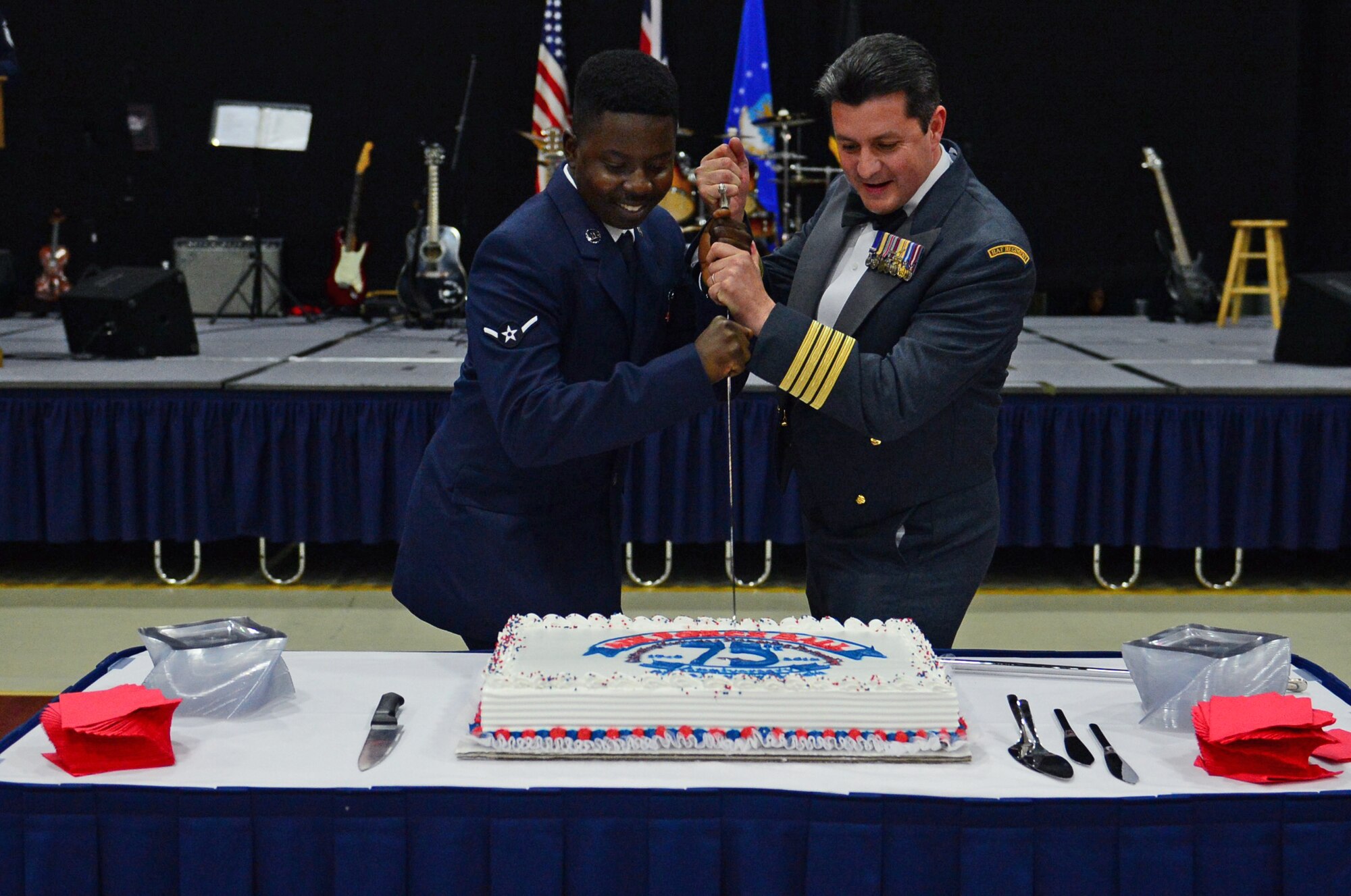 Airman Elijah Baker, 48th Force Support Squadron force management apprentice, and Phil Lester, Group Captain at Royal Air Force High Wycombe, participate in a cake-cutting ceremony during the Air Force’s 68th birthday, in conjunction with the 75th anniversary of the Battle of Britain celebration at RAF Lakenheath, England, Sept. 18, 2015. Traditionally, the individuals with the least and greatest amount of time in service make the first cut. (U.S. Air Force photo by Senior Airman Erin O’Shea/Released)
