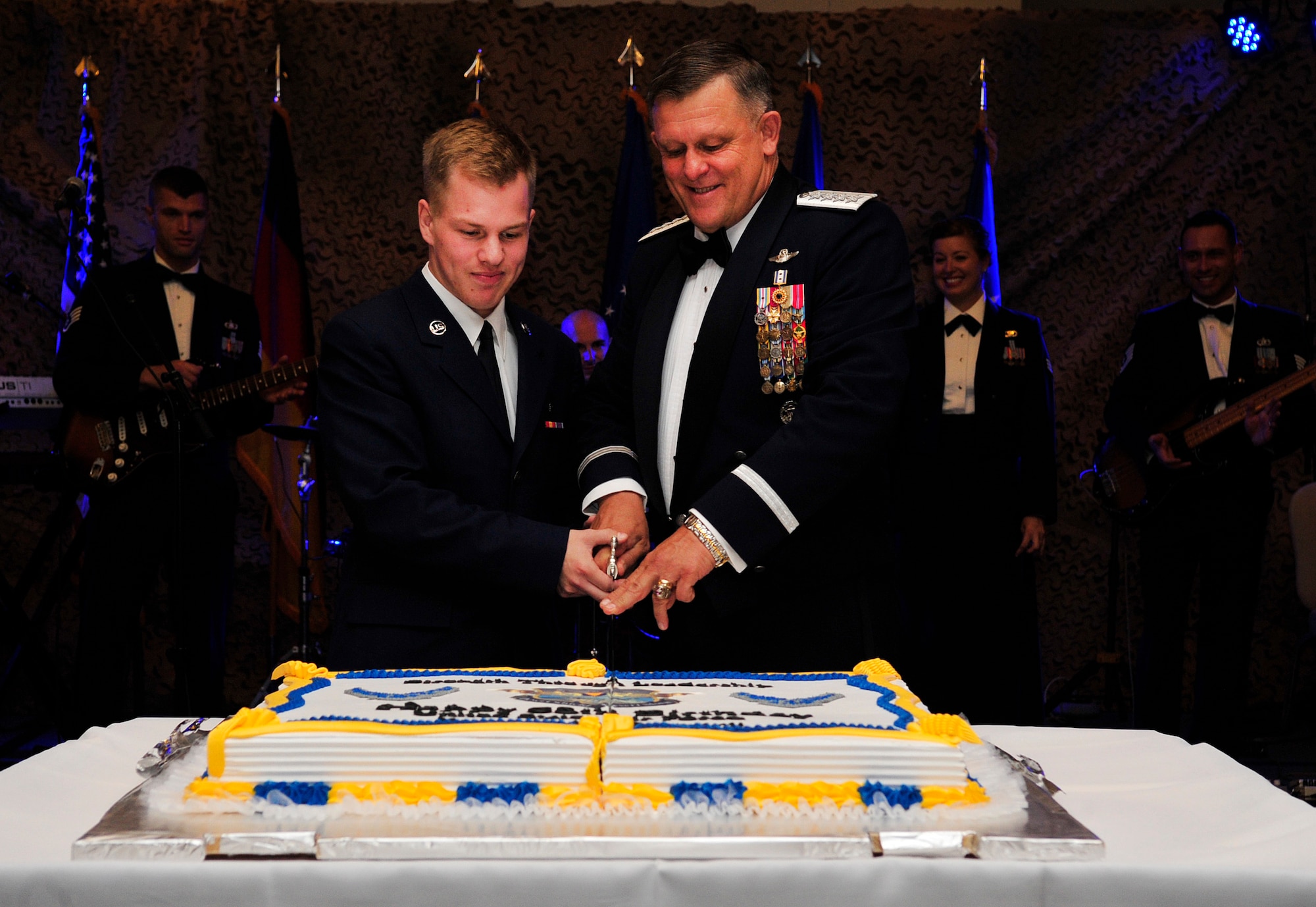 Airman Ryan Darish, 86th Medical Support Squadron uniform business office technician, and Gen. Frank Gorenc, U.S. Air Forces in Europe and Air Forces Africa commander, cut a cake during the Air Force Ball Sept. 12, 2015, at Ramstein Air Base, Germany. The cake-cutting ceremony is an Air Force tradition in which the lowest and highest ranking Airmen in the room cut the cake together. (U.S. Air Force photo/Airman 1st Class Larissa Greatwood)