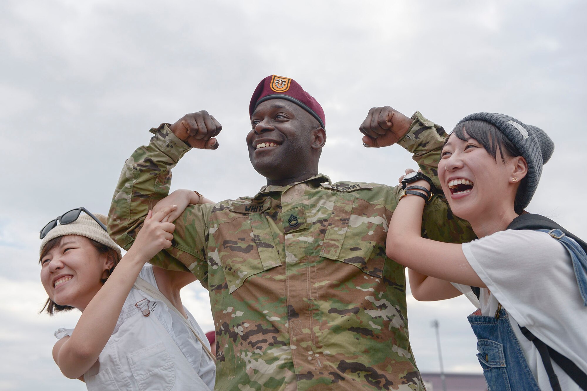 A US Soldier with the 1st Battalion, 1st Special Operations Group (Airborne), takes a photo with girls during the Japanese-American Friendship Festival at Yokota Air Base, Japan, Sept. 20, 2015. The annual event, aimed at increasing bilateral relationships between the US and Japan communities, hosted more than 185,000 attendees. (U.S. Air Force photo by Staff Sgt. Cody H. Ramirez/ Released)