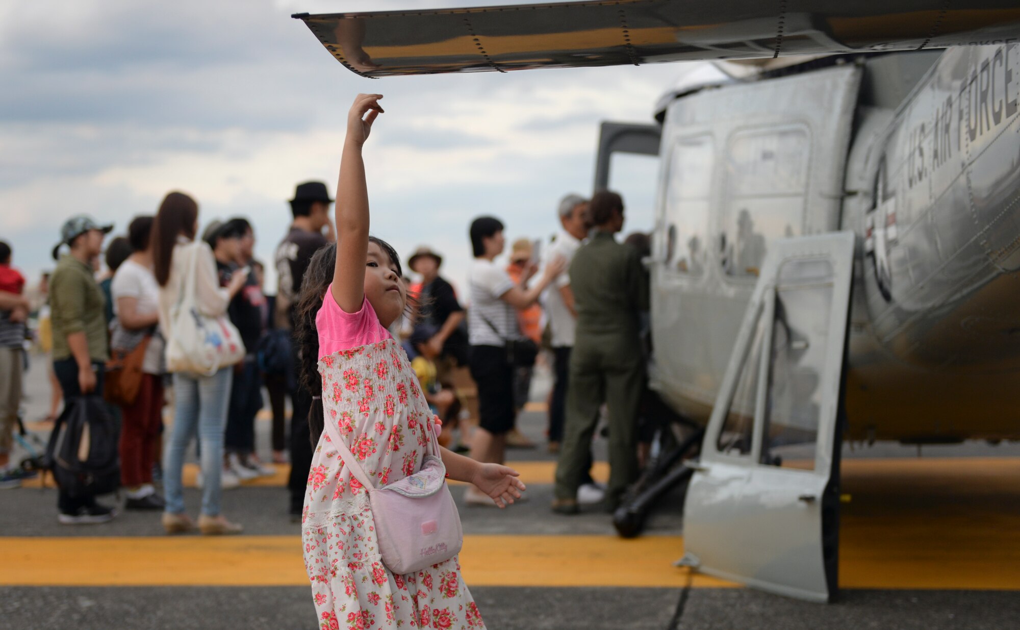 A young guest attempts to touch the tail of a UH-1N Iroquois during the Japanese-American Friendship Festival at Yokota Air Base, Japan, Sept. 19, 2015. The festival is designed to bolster the bilateral relationship shared between the United States and Japan. (U.S. Air Force photo by Airman 1st Class Delano Scott/Released)