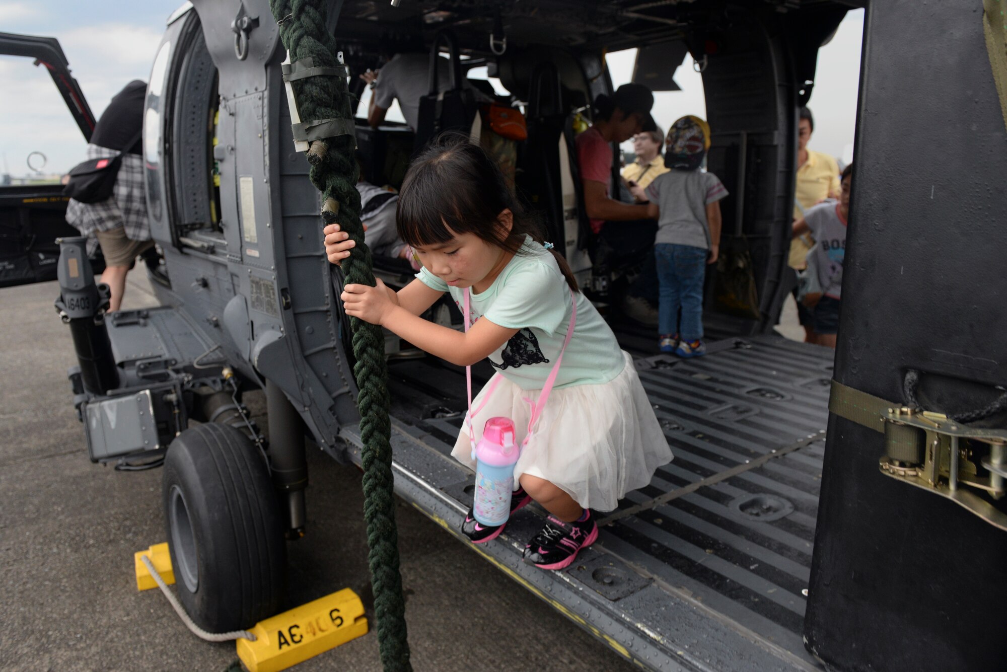 A young guest exits a HH-60 Pave Hawk during the Japanese-American Friendship Festival at Yokota Air Base, Japan, Sept. 19, 2015. The festival is designed to bolster the bi-lateral relationship shared between the United States and Japan. (U.S. Air Force photo by Airman 1st Class Delano Scott/Released)