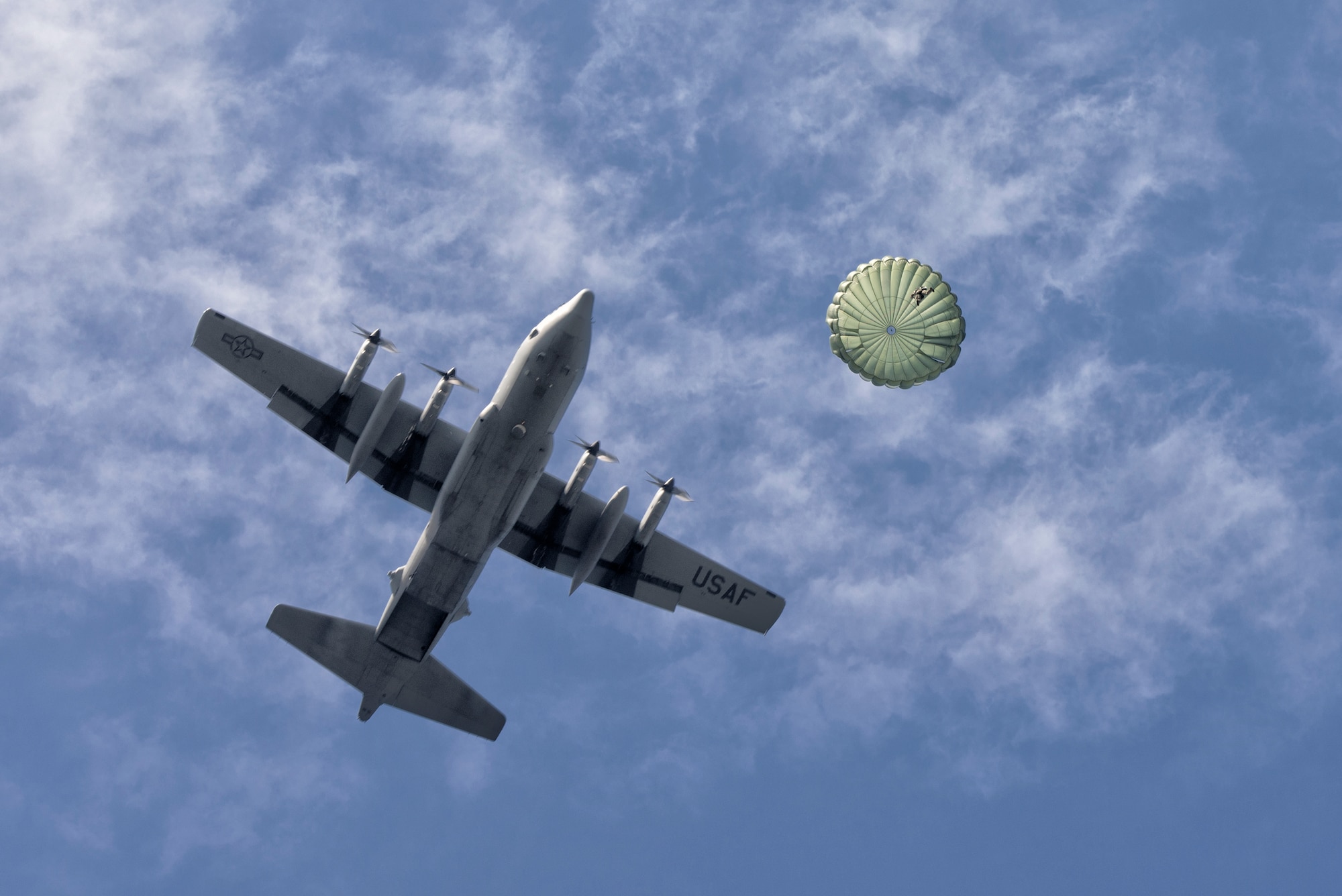 A U.S. soldier with the 1st Battalion, 1st Special Forces Group (Airborne), conducts an airdrop jump demonstration from a C-130 Hercules over Yokota Air Base, Japan, during the Japanese-American Friendship Festival, Sept. 20, 2015. The demonstration was one of many events during the weekend that showcased U.S. military capabilities. (U.S. Air Force photo by Airman 1st Class Delano Scott/Released)