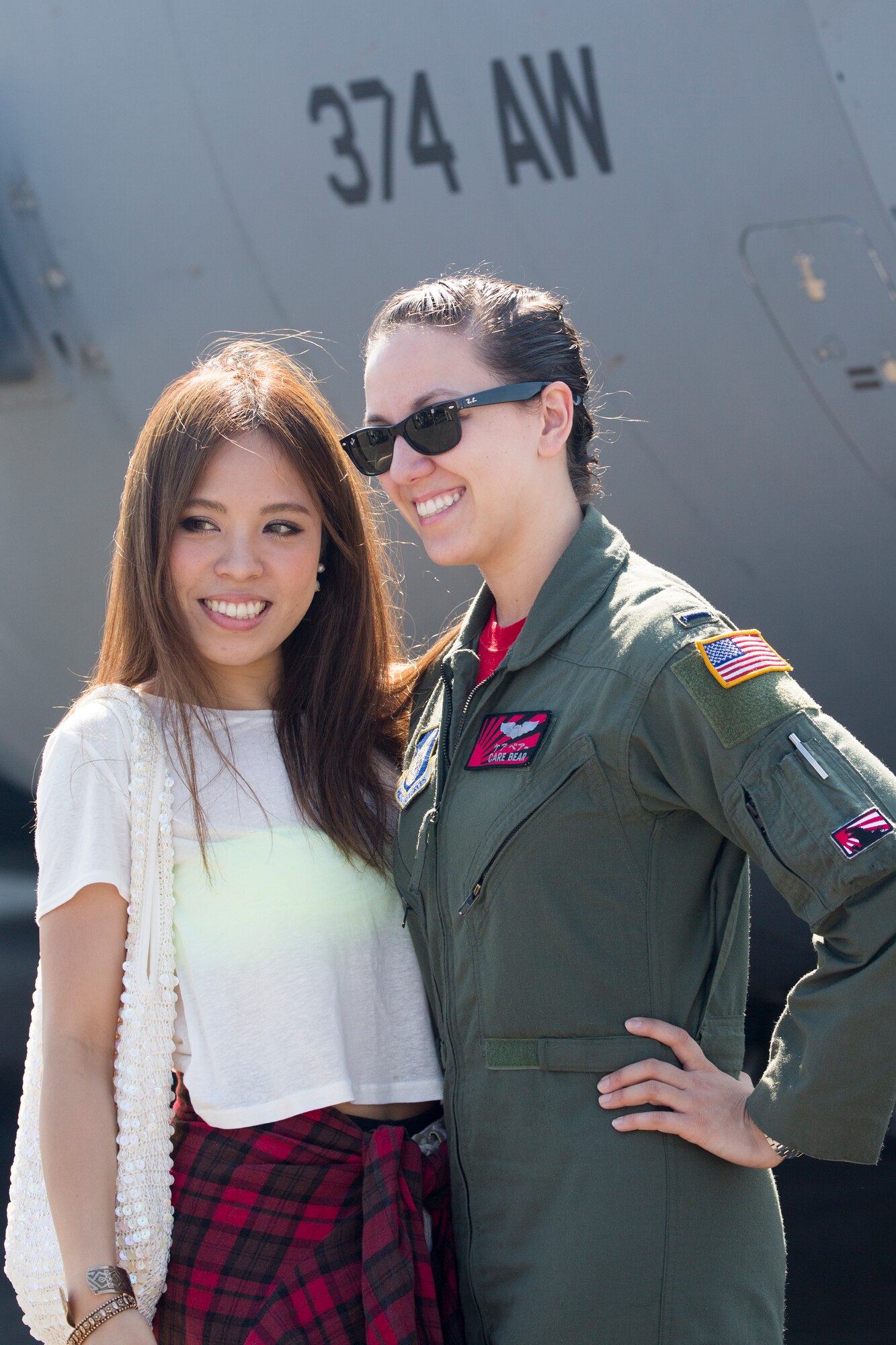 1st Lt. Sydney Croxton, 36th Airlift Squadron C-130 pilot, poses for a photos with a local guest during the Japanese-American Friendship Festival at Yokota Air Base, Japan, Sept. 20, 2015. Over a span of two days, 185,000 patrons attended the festival. (U.S. Air Force photo by Osakabe Yasuo/Released) 