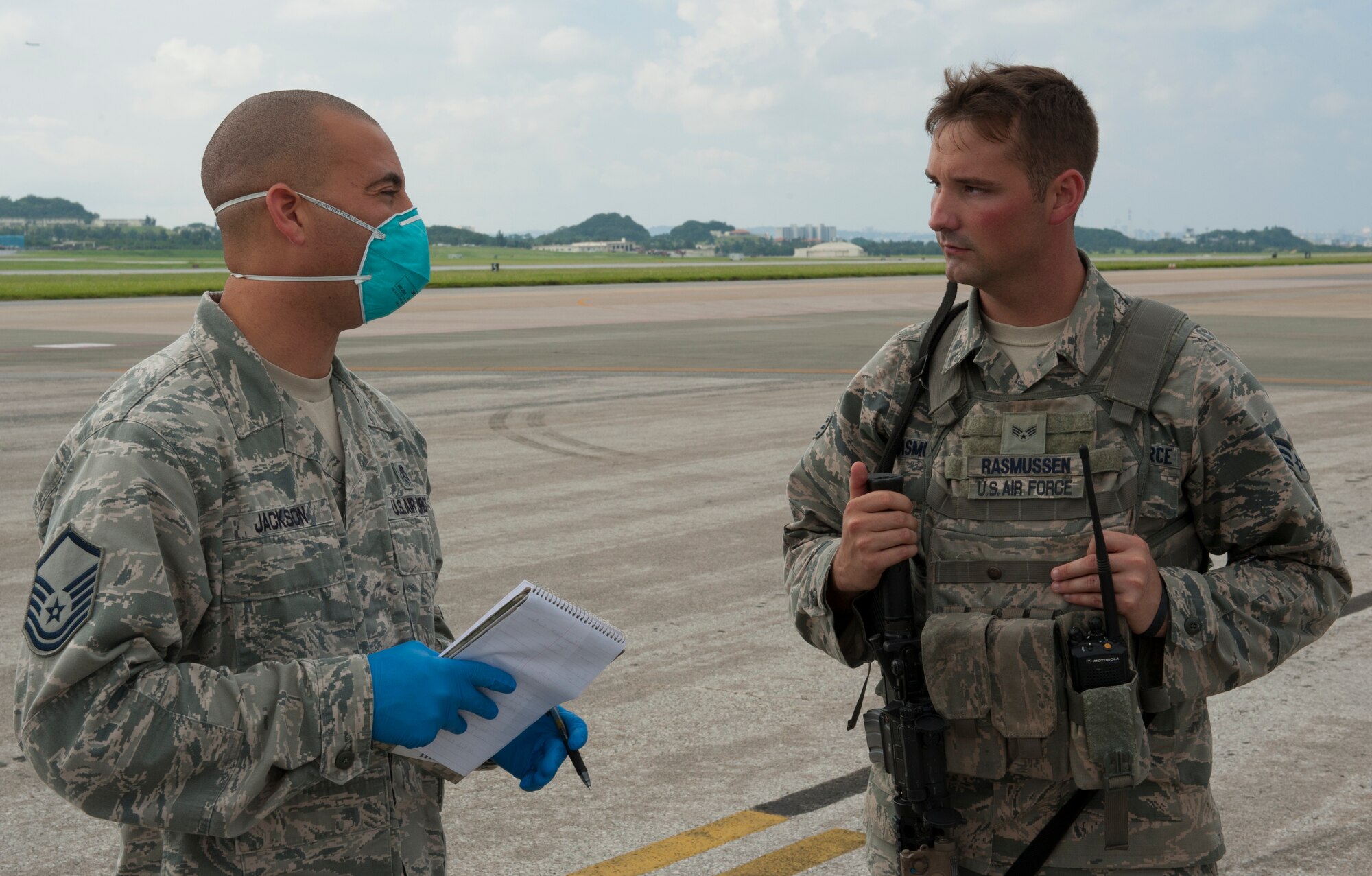 U.S. Air Force Master Sgt. Eric Jackson, 18th Aerospace Medicine Squadron NCO in charge of the community health element, and Senior Airman David Rasmussen, 18th Security Forces response force member, coordinate efforts during a medical emergency management exercise Sept. 21, 2015, at Kadena Air Base, Japan. The exercise was to test Kadena’s readiness and their ability to work with other agencies on base to ensure a smooth and efficient process during a medical emergency. (U.S. Air Force photo by Airman 1st Class Zackary A. Henry)