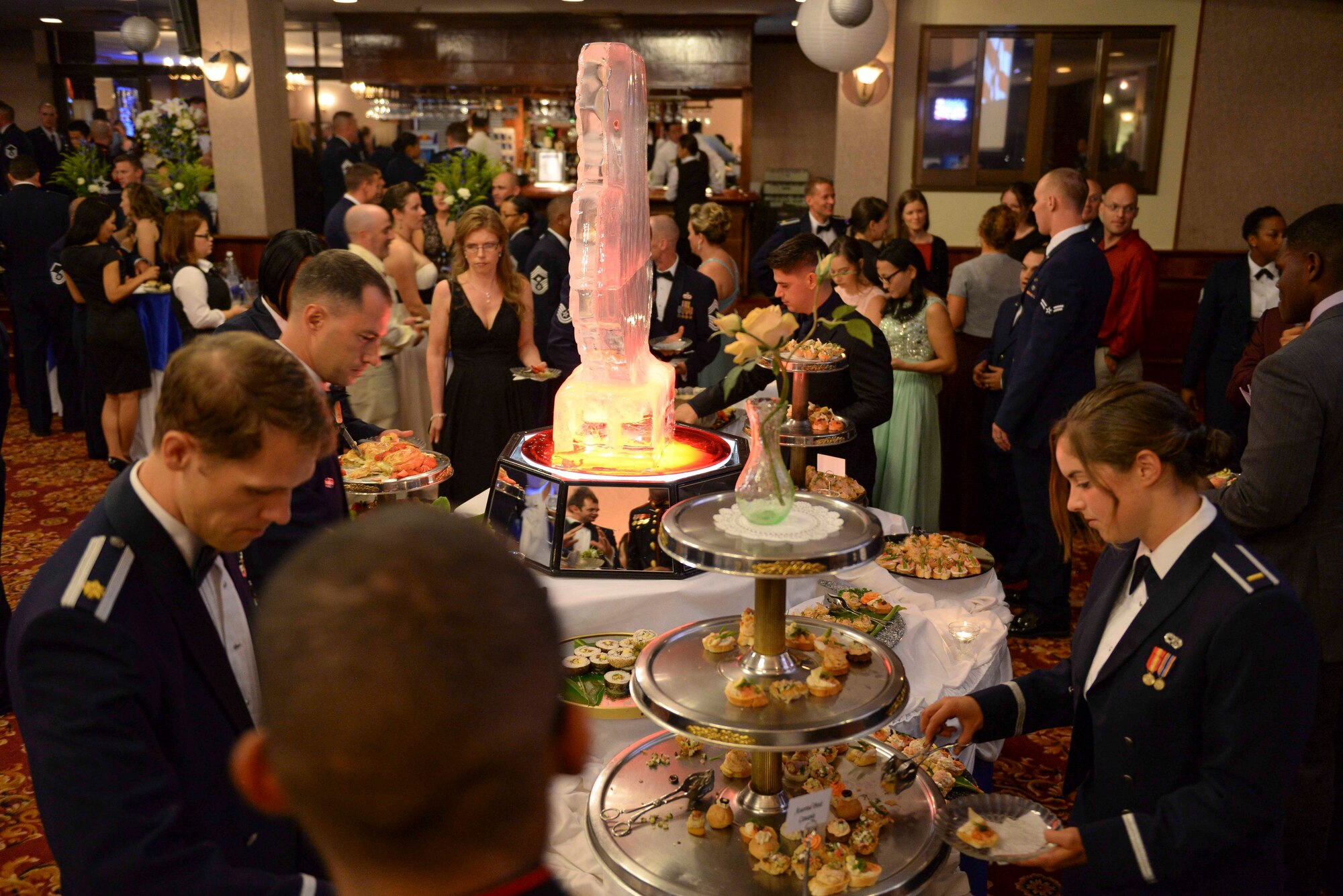 Attendees of the 2015 Air Force Ball on Kadena Air Base help themselves to hors d'oeuvres during social hour Sept. 19, 2015, at the Rocker NCO club on Kadena Air Base, Japan. The event was held in celebration of the Air Force’s 68th birthday and to stress the need for a culture of trust and respect that will enable resilient Airmen to stand ready to fight tonight. (U.S. Air Force photo by Senior Airman John Linzmeier)