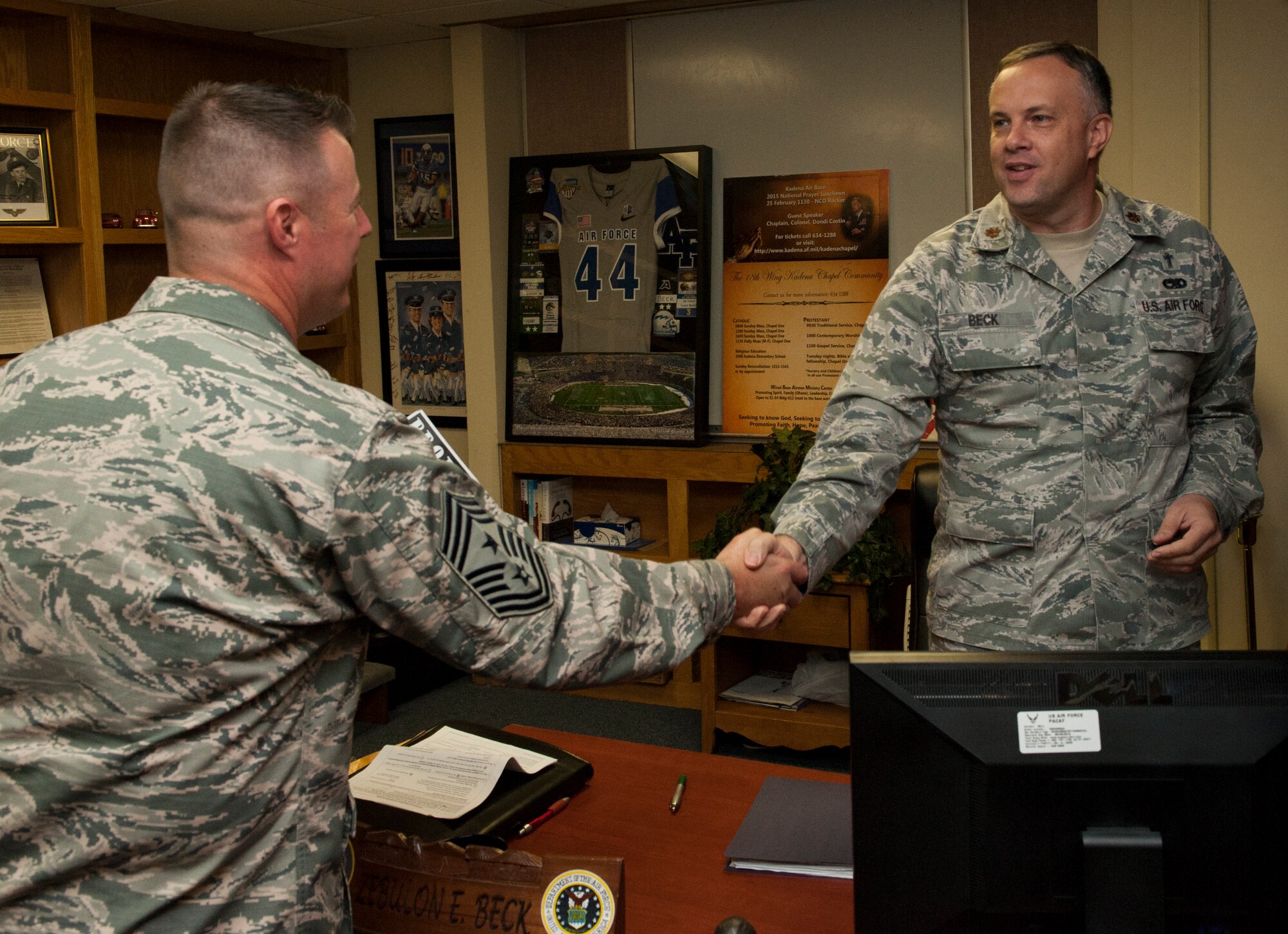 U.S. Air Force Chief Master Sgt. Charles Hoffman, 18th Wing command chief, shakes hands with Maj. Zebulon Beck, 18th Wing chaplain, as Hoffman makes his rounds visiting people and programs in support of Project 22 Sept. 21, 2015, on Kadena Air Base, Japan. The goal of Project 22 is to raise awareness of the many programs available to Airmen for them to get help and eliminate suicide. (U.S. Air Force photo by Airman 1st Class Corey M. Pettis)