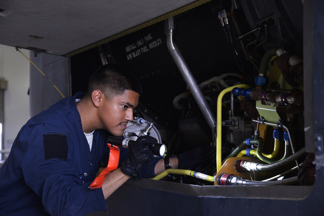 Senior Airman Alvaro inspects the right engine bay of an RQ-4 Global Hawk during a preflight at an undisclosed location in Southwest Asia September 14, 2015. Alvaro is a crew chief assigned to the 380th Expeditionary Aircraft Maintenance Squadron. (U.S. Air Force photo/Tech. Sgt. Christopher Boitz)