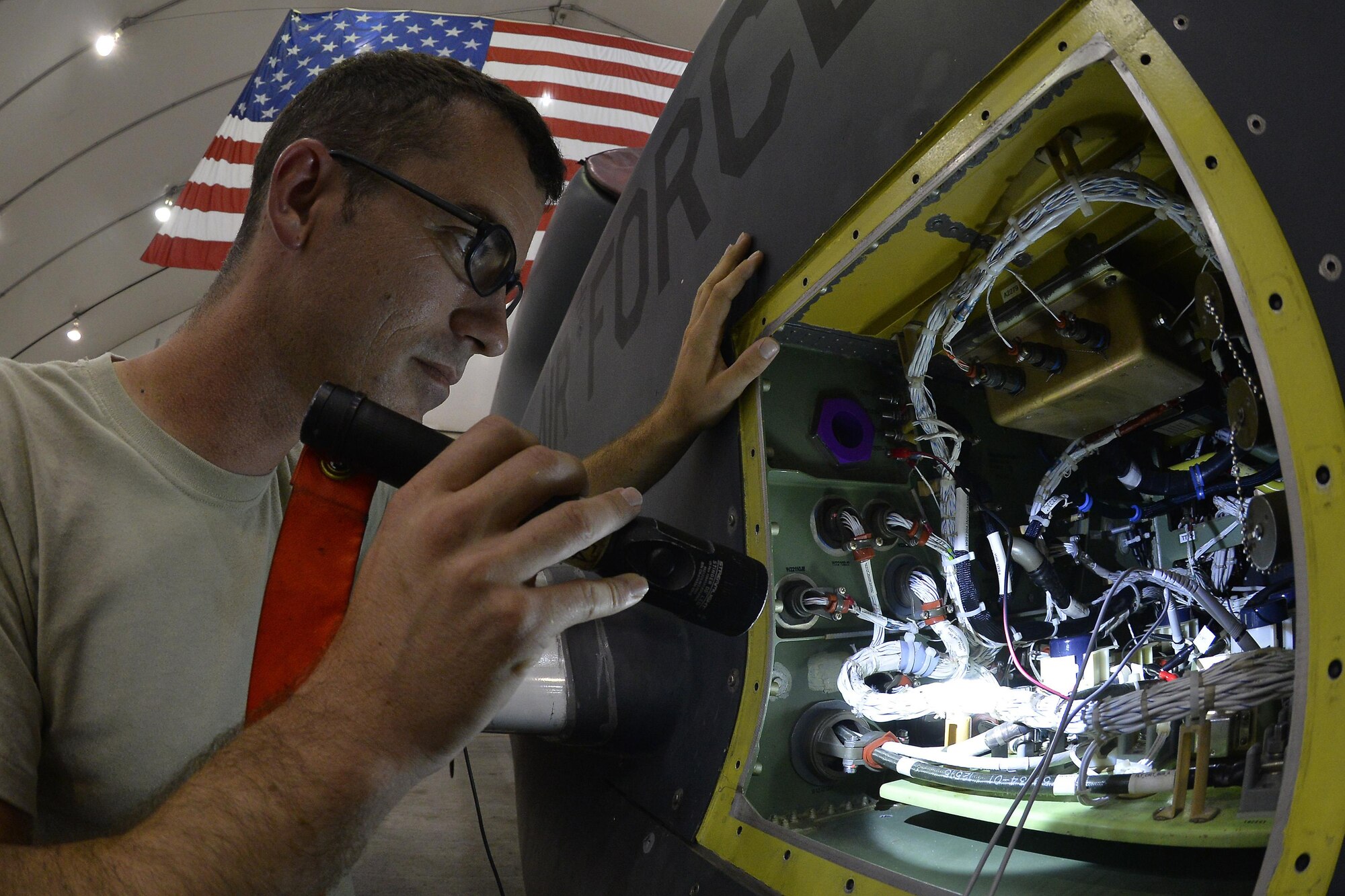 Tech. Sgt. Jon troubleshoots an RQ-4 Global Hawk for stray voltage during an inspection at an undisclosed location in Southwest Asia September 18, 2015. Jon is a flightline expeditor assigned to the 380th Expeditionary Aircraft Maintenance Squadron. (U.S. Air Force photo/Tech. Sgt. Christopher Boitz)