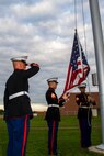 Marines from Recruiting Substation Central Michigan raise the United States flag during the H.H. Dow vs. Flint Southwestern football game, Sept. 18, 2015. The game was part of a Wounded Warriors Project fund drive.