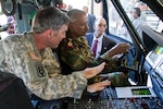 Chief Warrant Officer Kevin Keith discusses the capabilities of a UH-60 Black Hawk with Lt. Col. Chakib Mahamed Ali, deputy commander of the Djibouti Air Force, during a visit to the Kentucky Guard’s Army Aviation Support Facility in Frankfort, Kentucky, Sept. 15, 2015. Members of the Djibouti military toured several sites across Kentucky as part of the country’s new partnership with the Kentucky Guard. 
