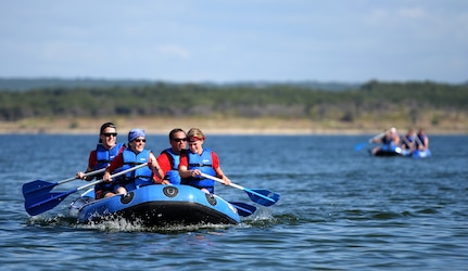 Rambler 120 competitors row their raft during the 2-mile rafting portion of the annual competition Sept. 19, 2015 at Joint Base San Antonio Recreation Park at Canyon Lake. The Rambler 120, which is hosted by the 502nd Force Support Squadron, features four- and eight-person teams that engage in a friendly, but hard-fought, competition that challenges participants with a 22-mile bike race, 6-mile run, 2-mile raft race and a mystery event. (U.S. Air Force photo by Airman 1st Class Stormy Archer)