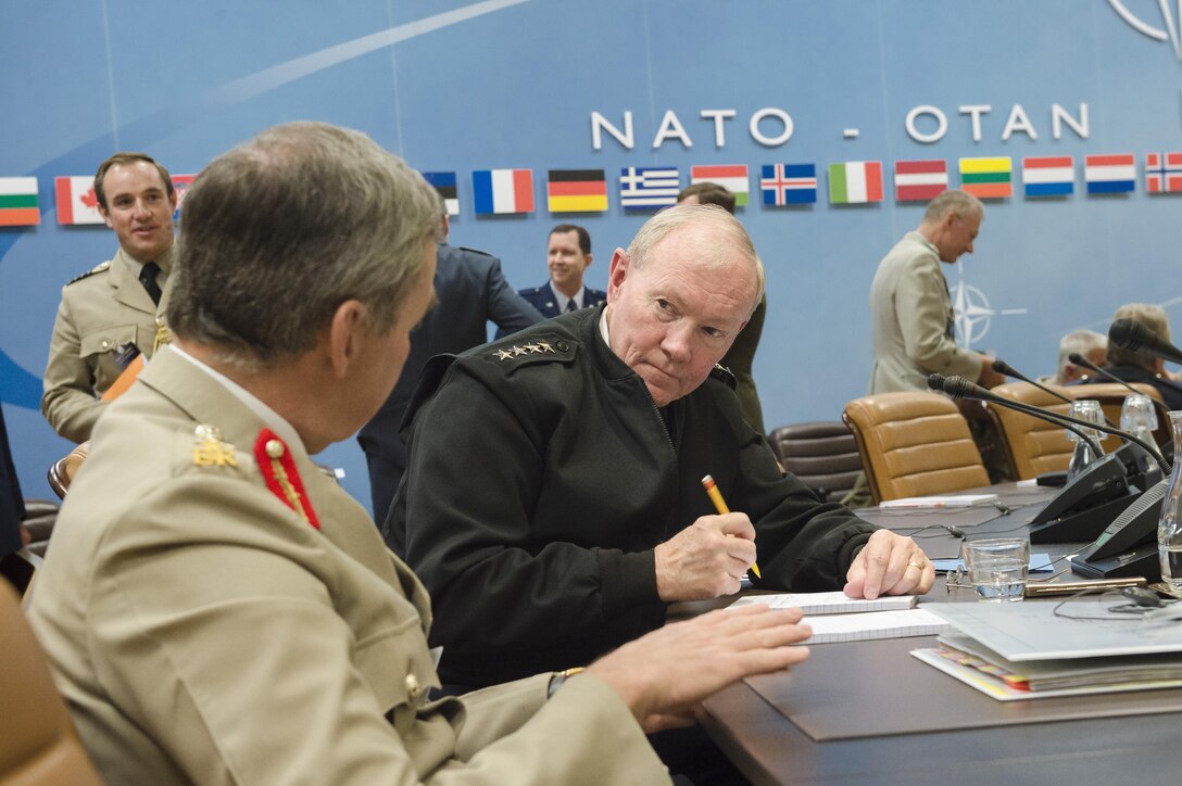 18th Chairman of the Joint Chiefs of Staff Gen. Martin E. Dempsey listens to British Gen. Nicholas Houghton, chief of the Defence Staff of the British Armed Forces, during the 173rd Military Committee in Chiefs of Defence Session at NATO headquarters in Brussels, Belgium, May 21, 2015. DoD photo by U.S. Army Staff Sgt. Sean K. Harp