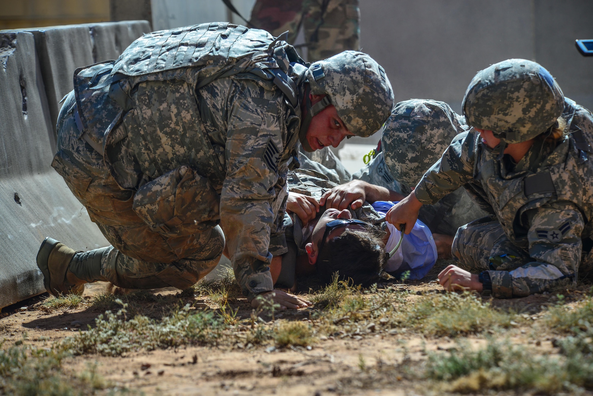 Medics from Langley Air Force Base, Va., pull a simulated patient to safety Sept. 17, 2015 at Melrose Air Force Range, N.M. Twenty-one teams of elite EMTs from 22 installations across the Air Force convened at Cannon Air Force Base, N.M., for two days of innovative, high-octane competition Sept. 17-18. Throughout the rodeo, teams were required to execute lifesaving missions under the critical eye of expert evaluators, demonstrating accurate techniques and effective implementation. (U.S. Air Force photo/Airman 1st Class Shelby Kay-Fantozzi)
