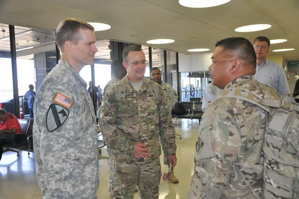 New York District Commander Col. David A. Caldwell (left) converses with SFC Roland Tajalle, right, at Newark Airport (NJ) just after the District's Forward Engineering Support Team - Advanced (FEST-A) returned from a nine-month deployment to Afghanistan completing over 60 projects for U.S. and Coalition forces with a design value exceeding $36 million. Also pictured are MAJ Brett Medsker, FEST-A Commander, center, and Sean O'Donnell,chief, emergency management/readiness, in background, right.