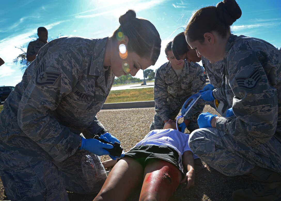 U.S. Air Force emergency medical technician personnel from Little Rock Air Force Base, Ark., simulate providing care for an animal attack victim during the EMT Rodeo Sept. 17, 2015 at Cannon Air Force Base, N.M. Twenty-one teams of elite EMTs from 22 installations across the Air Force convened at Cannon for two days of innovative, high-octane competition Sept. 17-18. Throughout the rodeo teams were required to execute their lifesaving mission under the critical eye of expert evaluators, demonstrating accurate technique and effective implementation. (U.S. Air Force photo/Staff Sgt. Alexx Pons)
