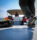 An Airman boards a boat before fixed-wing survival parachute drag and drop training at Hurlburt Field, Fla., Sept. 1, 2015. Aircrew members participate in fixed-wing water survival training tri-annually to maintain proficiency on skill sets such as canopy disentanglement, parachute drop and drag and life raft boarding. (U.S. Air Force photo by Senior Airman Meagan Schutter)