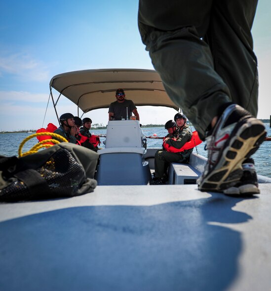 An Airman boards a boat before fixed-wing survival parachute drag and drop training at Hurlburt Field, Fla., Sept. 1, 2015. Aircrew members participate in fixed-wing water survival training tri-annually to maintain proficiency on skill sets such as canopy disentanglement, parachute drop and drag and life raft boarding. (U.S. Air Force photo by Senior Airman Meagan Schutter)