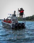 Russell Flowers, 19th Special Operations Squadron instructor, jumps in the water during fixed-wing survival parachute drag and drop training at Hurlburt Field, Fla., Sept. 1, 2015. This training was part of a fixed-wing water survival training conducted tri-annually to maintain proficiency on skill sets such as canopy disentanglement, parachute drop and drag and life raft boarding. (U.S. Air Force photo by Senior Airman Meagan Schutter)