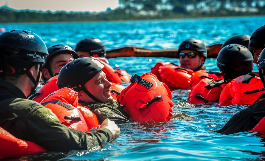 Maj. Steve Gregor, 4th Special Operation Squadron navigator, prepares to board a life raft during survival, evasion, resistance and escape during fixed-wing survival life raft boarding training on the Soundside at Hurlburt Field, Fla., Sept. 1, 2015. The training was part of a fixed-wing water survival training conducted tri-annually to maintain proficiency on skill sets such as canopy disentanglement, parachute drop and drag and life raft boarding. (U.S. Air Force photo by Senior Airman Meagan Schutter)