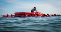 Airmen pull a life raft to shore during fixed-wing survival life raft boarding training on the Soundside at Hurlburt Field, Fla., Sept. 1, 2015. The training was part of fixed-wing water survival training conducted tri-annually to maintain proficiency on skill sets such as canopy disentanglement, parachute drop and drag and life raft boarding. (U.S. Air Force photo by Senior Airman Meagan Schutter)