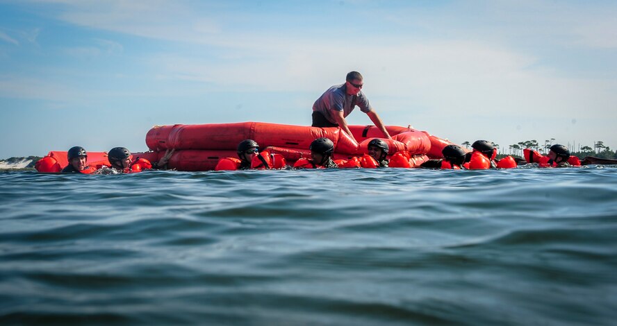 Airmen pull a life raft to shore during fixed-wing survival life raft boarding training on the Soundside at Hurlburt Field, Fla., Sept. 1, 2015. The training was part of fixed-wing water survival training conducted tri-annually to maintain proficiency on skill sets such as canopy disentanglement, parachute drop and drag and life raft boarding. (U.S. Air Force photo by Senior Airman Meagan Schutter)