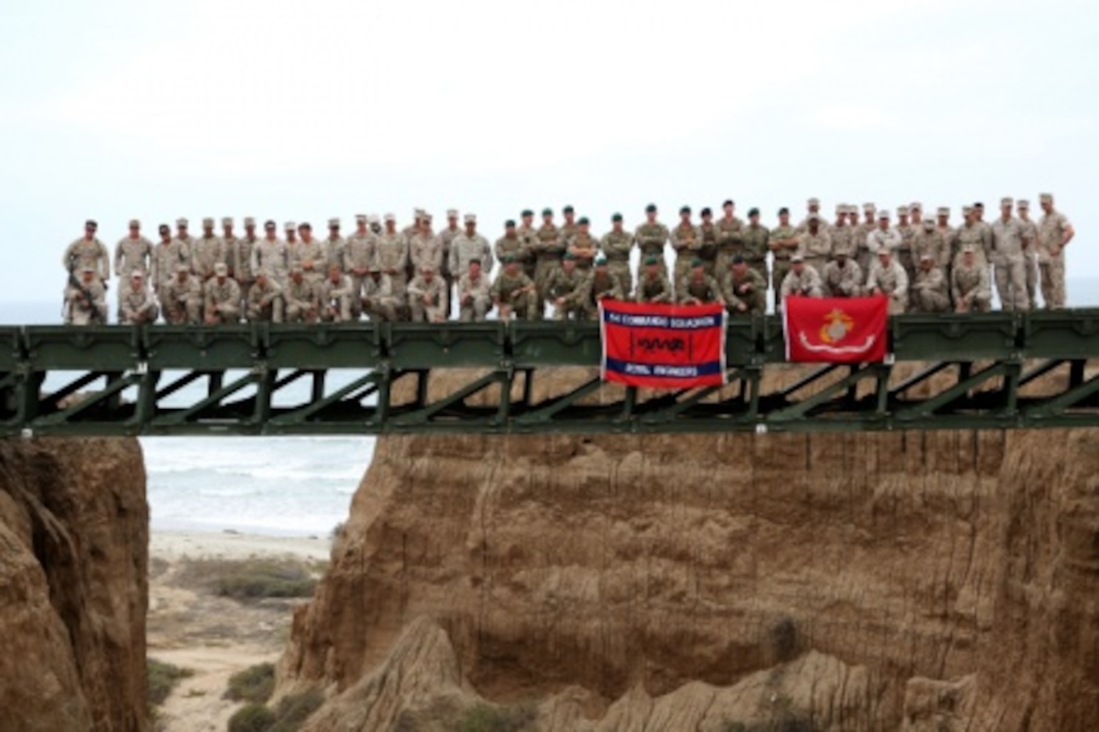 Engineers from Bridge Company, 7th Engineer Support Battalion, 1st Marine Logistics Group and 1st Combat Engineer Battalion, 1st Marine Division as well as members of British 54 Commando Squadron Royal Engineers stand atop a medium girder bridge they built aboard Camp Pendleton, Calif., Sept. 21, 2015. Marines from 7th ESB and 1st CEB are conducting various engineer training events alongside their British counterparts in coming weeks as part of annual large-scale exercise Black Alligator.