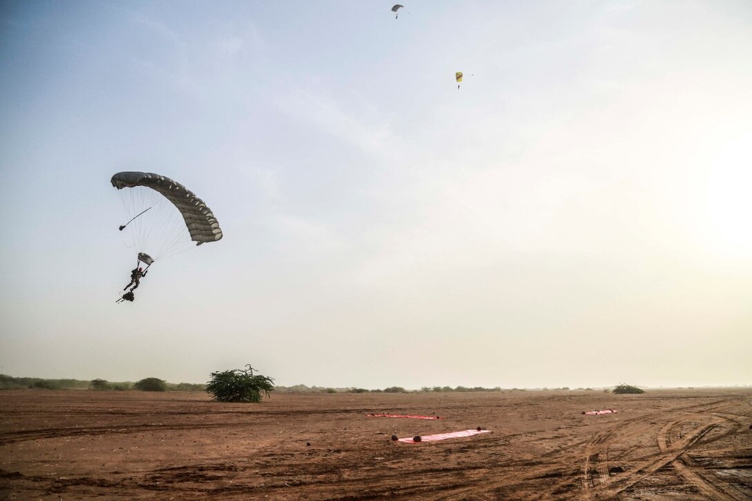 CAMP LEMONNIER, Djibouti (Sept. 14, 2015) A French paratrooper glides to the ground from a French C-160 alongside members of the 15th Marine Expeditionary Unit’s Force Reconnaissance Detachment. Elements of the 15th MEU are conducting bilateral training with the 5th Overseas Combined Arms Regiment (RIAOM) and other French forces in Djibouti in order to improve interoperability between the MEU and the French military. (U.S. Marine Corps photo by Sgt. Steve H. Lopez/Released)
